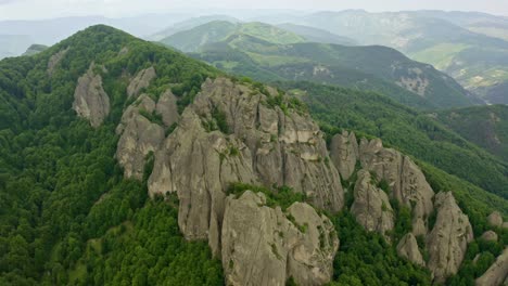 drone retreating and revealing the expanse of the rock phenomenon karadzhov kamak, one of the peaks of the famous energy triad, in northern rhodopes in central bulgaria