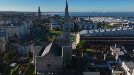 maritime museum, county dublin, dun laoghaire, september 2024. drone orbits clockwise and descends showcasing the mariners' church with views of the lexicon library and the harbour in the background.