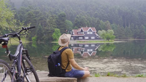 Adventurous-traveler-is-resting-by-the-lake.