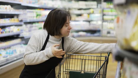 Female-worker-with-Down-syndrome-restocking-goods-from-the-shopping-cart