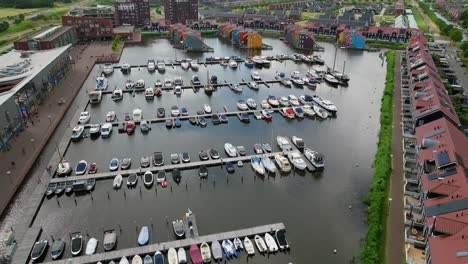 aerial approach view of docked recreational boats on a small harbour with moorings for small vessels