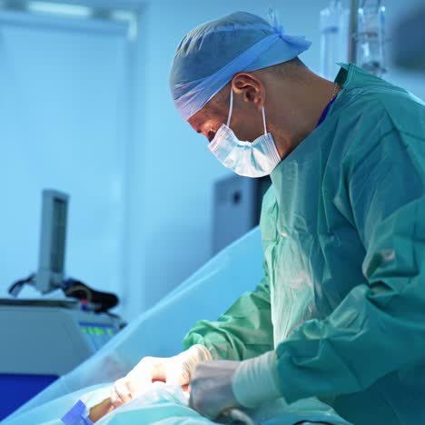 doctor removes the fat during the liposuction of the patient with anesthesia. professional surgeon works with surgical instrument while doing a surgery. lipomodelling