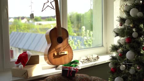 Flat-lay-composition-with-guitar-and-Santa-hat,-space-for-text.-Christmas-music