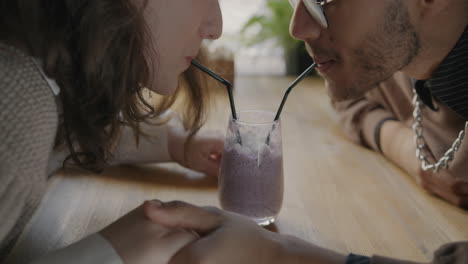couple sharing a smoothie