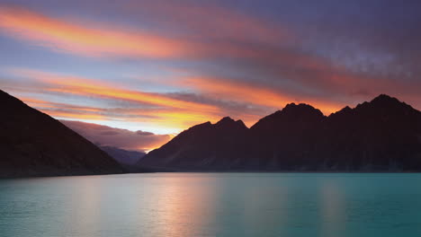 vibrant sunset over majestic mountains and reflecting lake