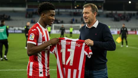 exciting moment as young football talent receives jersey from coach in emotional post-match ceremony celebrating player's debut and future aspirations