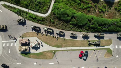 an aerial view directly above parked vintage tanks and other military vehicles