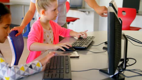 asian female teacher teaching schoolkids on computer in the school 4k