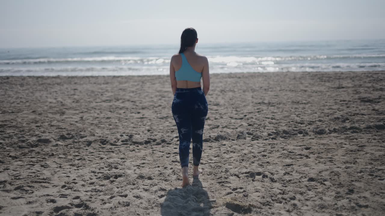 Woman Walking on a Beach