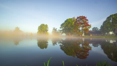 House-on-lake-time-lapse-transition-season-change-spring-summer-autumn-winter,-Latvia