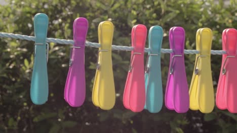 Pegs-hanging-on-a-washing-line-on-a-windy-day