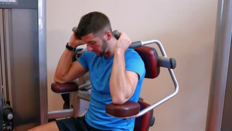 man using weights machine in gym