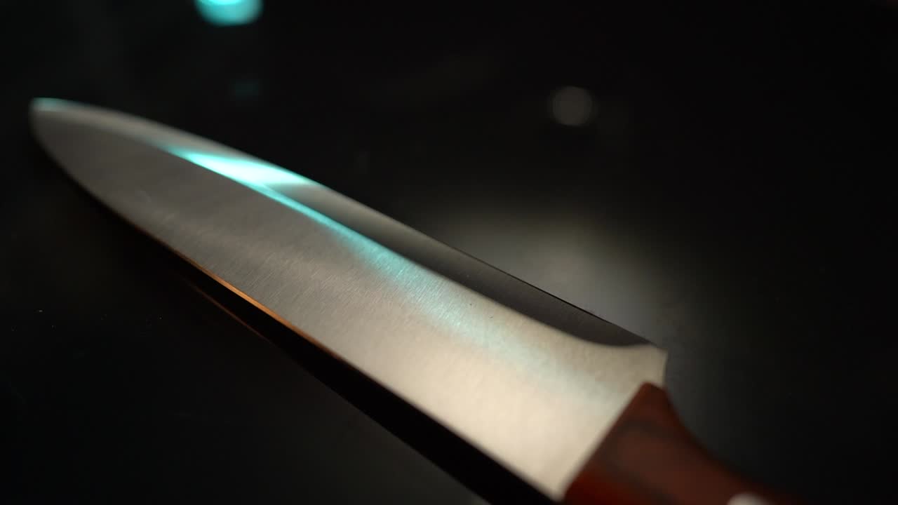 Kitchen knife on table with blue lighting - close up