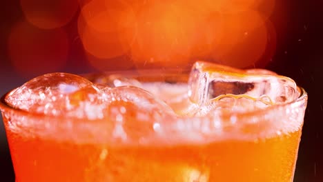 glass of soft drink. ice soft drink with splashing bubbles slow motion on a blurry light ,blurry background.