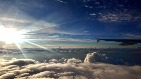 watching the sunrise, sunset out of a plane, stunning view at the sun with clouds underneath, pov, copy space