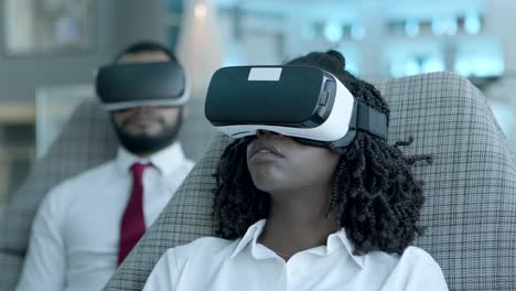 focused young woman in vr headset