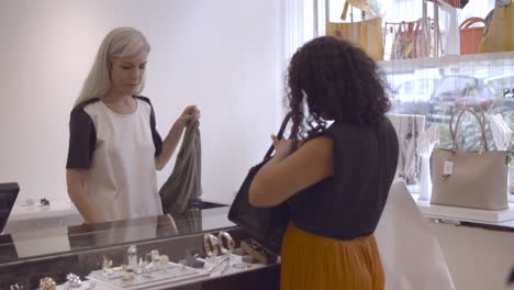 latin woman buying cloth in fashion store