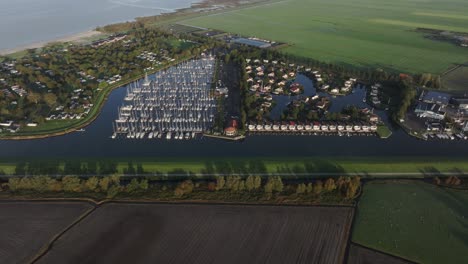 Aerial-view-of-small-harbour-with-sailboats-during-winter,-Workum,-Netherlands