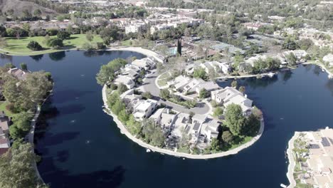 aerial view of calabasas city neighborhood luxurious lakeside homes, rising shot