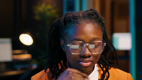 African american student writing reports for her final course essay