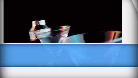 abstarct blue shapes over olives falling into cocktail glasses against black background