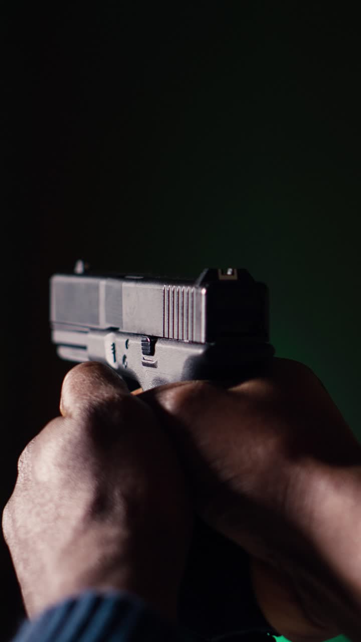 Vertical video Shooting gallery client using handgun to hit paper targets with ammo, close up