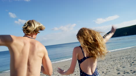 couple running on beach