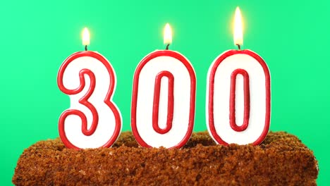 cake with the number 300 lighted candle. chroma key. green screen. isolated