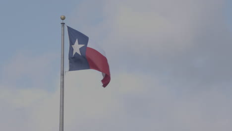 texas flag blowing in the wind in austin, texas