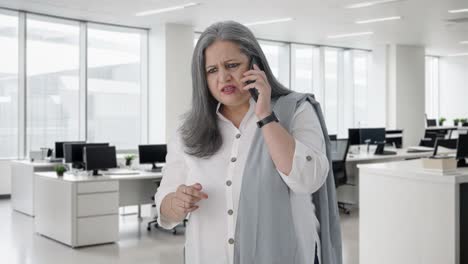 Angry-Indian-senior-businesswoman-shouting-on-call