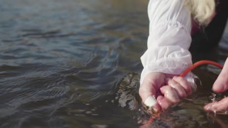 woman near a river with an injured arm