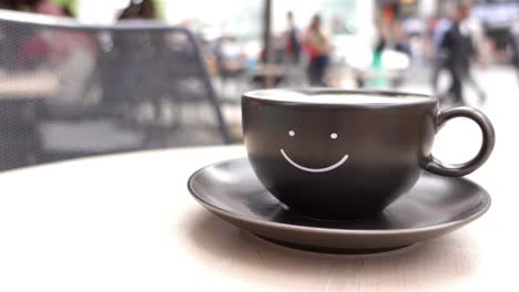 smiling coffee cup on an outdoor table