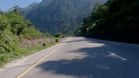 driving on a smooth winding road on a sunny day in nepal