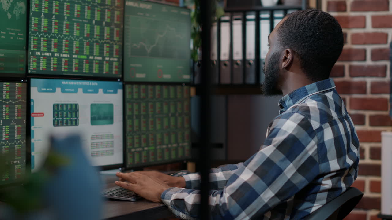 Male investor using forex exchange fund sales on multiple monitors