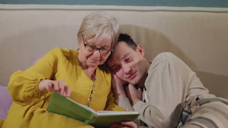 grandparent and grandchild enjoying a book together