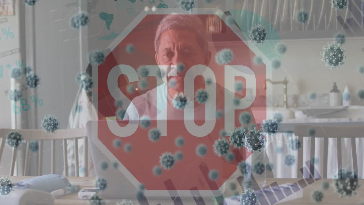 Animation of stop sign and virus cells over sad biracial man using laptop at home