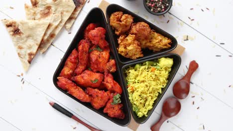 Spicy-indian-fried-chicken-served-with-curry-vegetable-rice--onion-bhajia--naan-bread