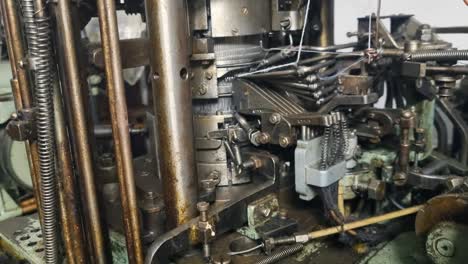 close-up of a dusty cam drum from a 1950s sock knitting machine, once a key component in yugoslavia’s textile industry, captured while in motion