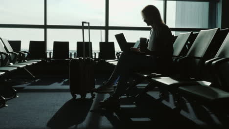 Business-Woman-Working-While-Waiting-For-Flight