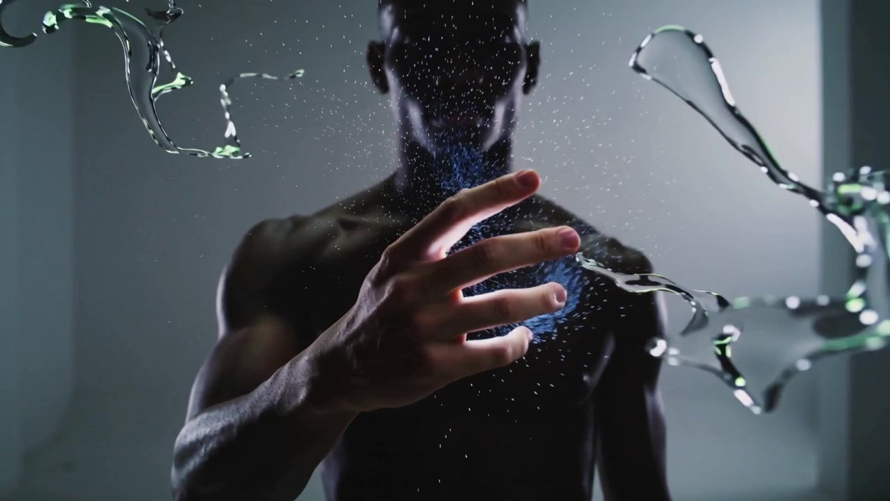 Bringing fingers closer, shirtless man manipulating blue orb in alcove, fragmenting liquid ribbons
