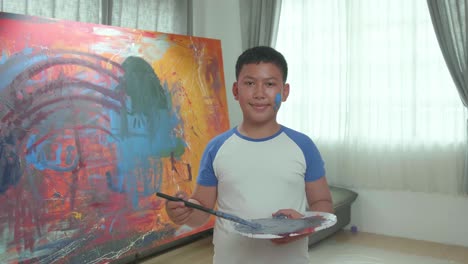 boy painting in a room