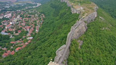 drone footage of the ancient ovech fortress near provadia bulgaria surrounded by green trees