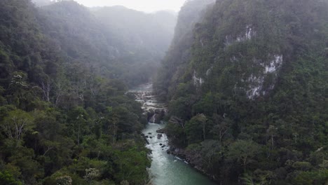 Rain-aerial-flight-to-Semuc-Champey-waterfall-in-steep-Guatemala-mtns