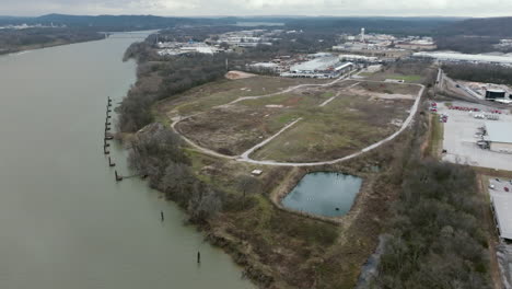 wide aerial footage of a epa superfund site in chattanooga, tn that is abandoned where the camera rotates around it.