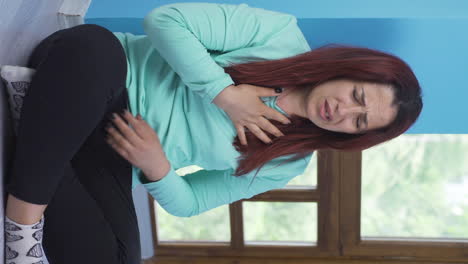 Vertical-video-of-Sick-woman-coughing-leaning-against-wall.-Hopeless.