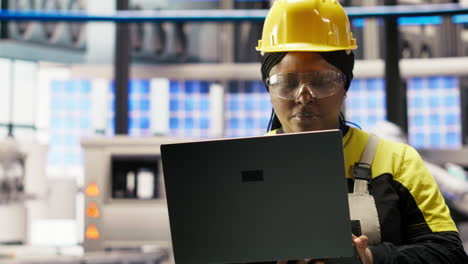 Vertical video Smart factory engineer using laptop to implement automated workflows