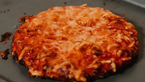 margarita pizza resting on baking tray after cooking