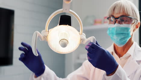 dentist adjusting dental light