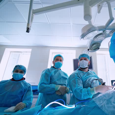 medical team in surgical room. doctors and assistant perform an operation with modern medical equipment in the hospital. health care concept.