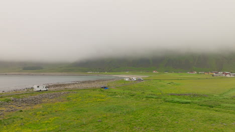 Flying-Towards-Unstad-Beach,-a-Popular-Surfing-Spot-On-A-Misty-Day-In-Norway